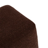 Close-up of a square ottoman corner upholstered in rich dark brown textured fabric against a white background.