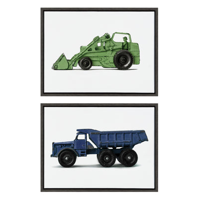 Framed canvas art set showing a vintage green toy tractor and a blue toy dump truck, each in a polystyrene frame.