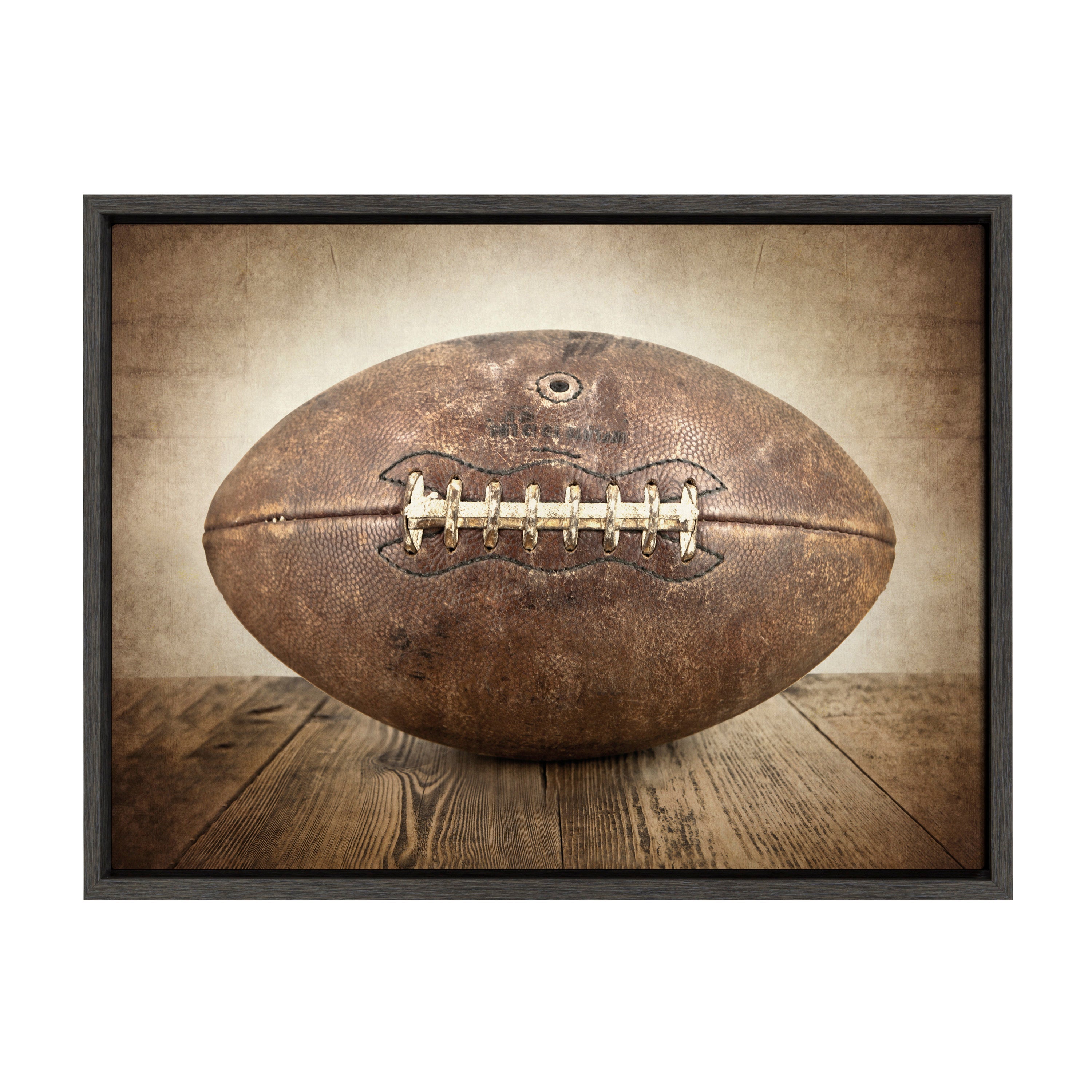 Sylvie Vintage Football framed canvas art in a modern floating polystyrene frame, shown hung on a wall.
