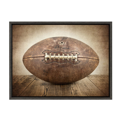 Sylvie Vintage Football framed canvas art in a modern floating polystyrene frame, shown hung on a wall.