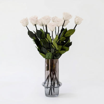 Long Stem White Roses arranged loosely showing full white rose blooms with long green stems