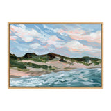 Impressionistic painting of Michigan sand dunes with green vegetation, blue ocean waves, and a sky filled with soft pink and white clouds, framed in light wood.
