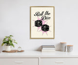 Framed canvas featuring black dice with white dots and the phrase 'Roll the Dice' in black script on a cream background with pink starbursts, hung above a white dresser with plants and patterned containers.