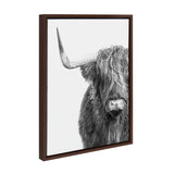 Black and white close-up portrait of a Highland cow with long, shaggy hair covering its eyes and a prominent curved horn, framed in dark wood.