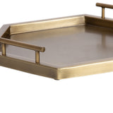 Hexagon-shaped decorative tray with a smooth, brushed gold-tone metal surface and tubular handles on two parallel sides.