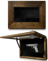 Wall-mounted wooden pistol display case with a clear glass front, shown closed above and open below revealing a black interior holding one ornate silver pistol.