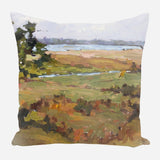 Square pillow featuring an impressionistic landscape painting of marshland with green grass, brown foliage, a tree on the left, and water in the background under a pale sky.