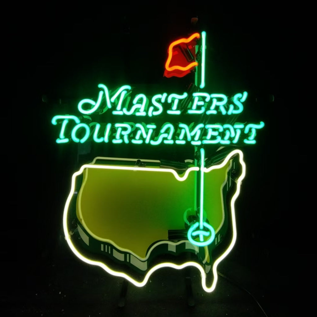 Neon sign showing a green lit 'Masters Tournament' text above an outline of the U.S. map in yellow with a green golf flag and red flag atop the outline.