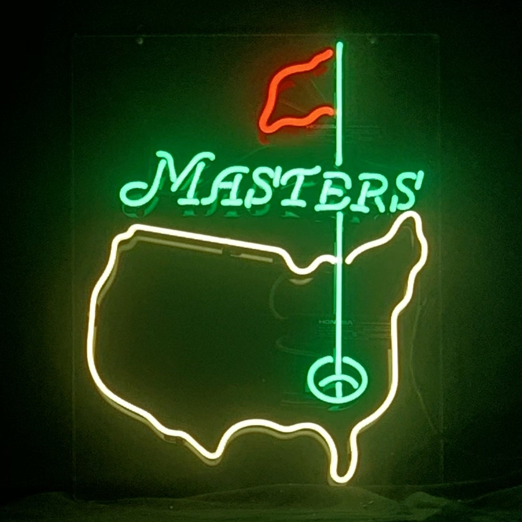 Neon sign depicting the United States outline in yellow with a green golf hole and red flag on a green pole, and the word 'MASTERS' in green above the map.