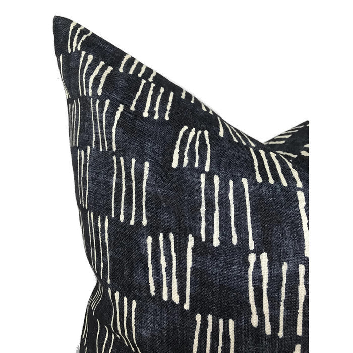 Indigo blue pillow cover with irregular vertical white matchstick line patterns, showing a close-up of the corner and fabric texture.
