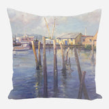 Pillow featuring a soft pastel painting of wooden pilings in water with boats and buildings in the background under a cloudy sky.