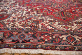 Close-up of a 9.5x10 Vintage Mehrivan Square Carpet with intricate red, blue, cream, and brown geometric and floral patterns and fringed edges.
