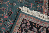 Close-up of a 6x9 vintage Indian Mohajeran Sarouk carpet featuring floral and leaf patterns in muted blue, pink, and beige tones with fringed edges.