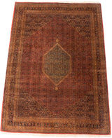 Rectangular vintage Indian Bijar carpet with a large central diamond medallion, tea-washed colors in red, brown, and dark blue, and intricate floral border patterns.