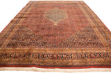Large 10x14 vintage Indian Bijar rug with a central medallion, intricate floral patterns, and a tea-washed red and brown color palette.