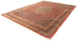 Vintage Indian Bijar carpet with a muted tea-washed red field, beige central medallion, intricate floral borders in black and gold, laid flat with visible fringes.