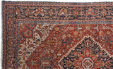Section of a vintage Bakshaish carpet featuring intricate floral and geometric patterns in red, blue, beige, and cream tones with detailed border designs.