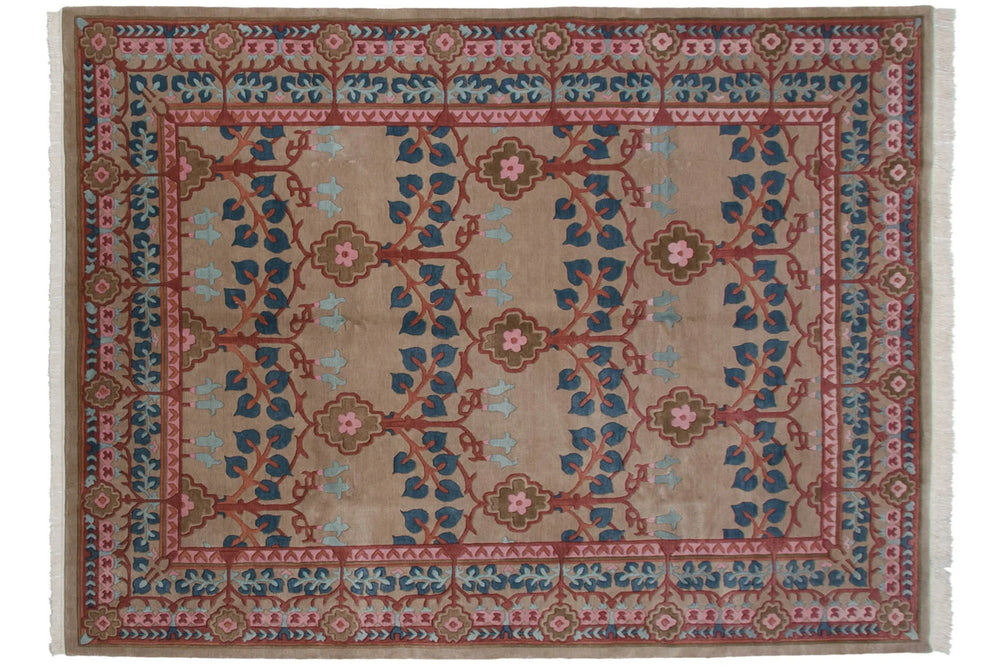 Vintage Indian Arts and Crafts carpet with a beige background, repeating floral and vine patterns in blue, red, and brown, bordered by geometric motifs in red and pink.
