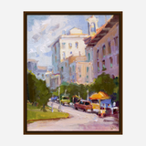 Impressionist-style painting depicting a bright city street with pastel buildings, green trees, and parked cars under a cloudy sky, viewed from street level.
