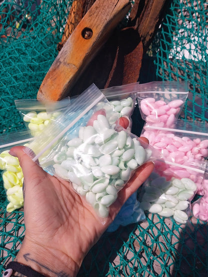 Bulk pastel dyed bubble shells in soft pink, blue, seafoam green, and yellow shades for crafting and DIY projects