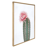 Framed canvas showing a green cactus with pink spines topped by a large soft pink flower, set against a white background and a thin wooden frame.