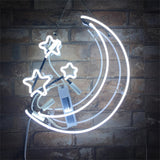 White neon light sign shaped as a crescent moon with three five-pointed stars on a dark brick wall background.