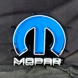 Blue and white neon Mopar logo light with a stylized 'M' shape above the word 'Mopar' in white neon, mounted on a black background.