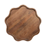 Top view of a round wooden tray with a scalloped edge and smooth grain pattern in warm brown tones.