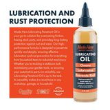 Clear plastic bottle with black pointed cap labeled Made Here Lubricating Oil, featuring orange and black text highlighting its cleaning, lubricating, and rust prevention qualities.