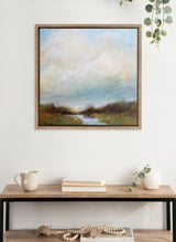 Framed landscape painting depicting a misty sky over a calm river with grassy banks, rendered in soft blues, greens, and earth tones.
