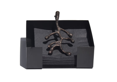 Vibhsa napkin holder featuring an antique flower bud design displayed on a wooden table