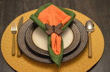 Set of four butterfly antique finish napkin rings in copper color arranged on a white surface