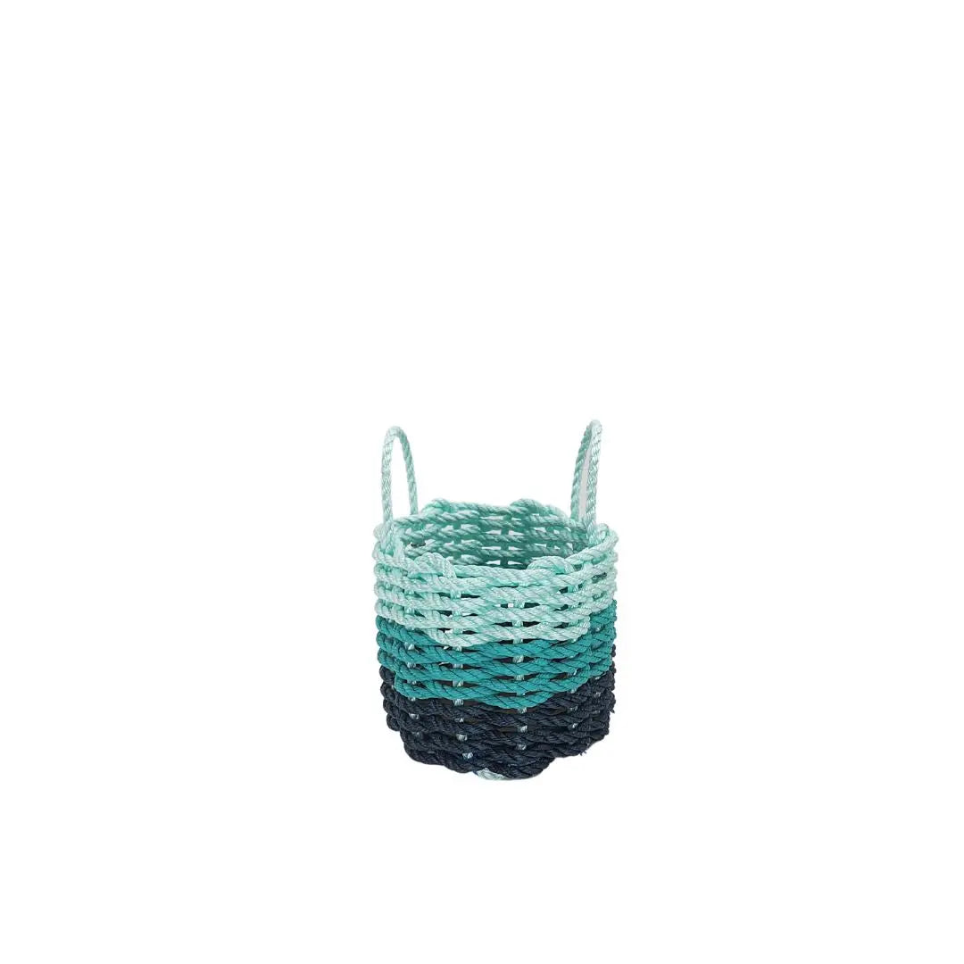Handmade lobster rope storage baskets in navy blue, teal, and seafoam colors in three sizes