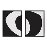 Two black-framed canvas abstracts with organic shapes; left features a white curve inside black, right shows a reversed black organic form on white background.
