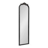 Tall rectangular wall mirror with a black frame and an arched top featuring decorative floral carvings in the center.