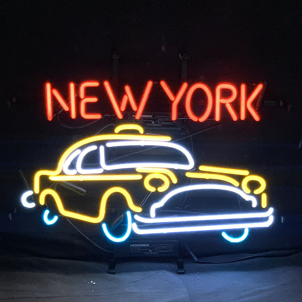 New York Taxi Car Neon Signs Light illuminated indoors on a wall with warm ambient lighting