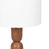 Close-up of a table lamp featuring a smooth, rounded wooden base with warm brown tones and a simple white cylindrical lampshade.