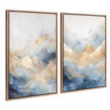 Set of two framed canvas art pieces depicting abstract blue and beige mountains with soft gradients and cloud-like effects in gold-tone beaded frames.