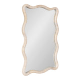 Tall rectangular mirror with a wavy scalloped frame wrapped in light natural rattan, blending soft beige tones with subtle texture variations.