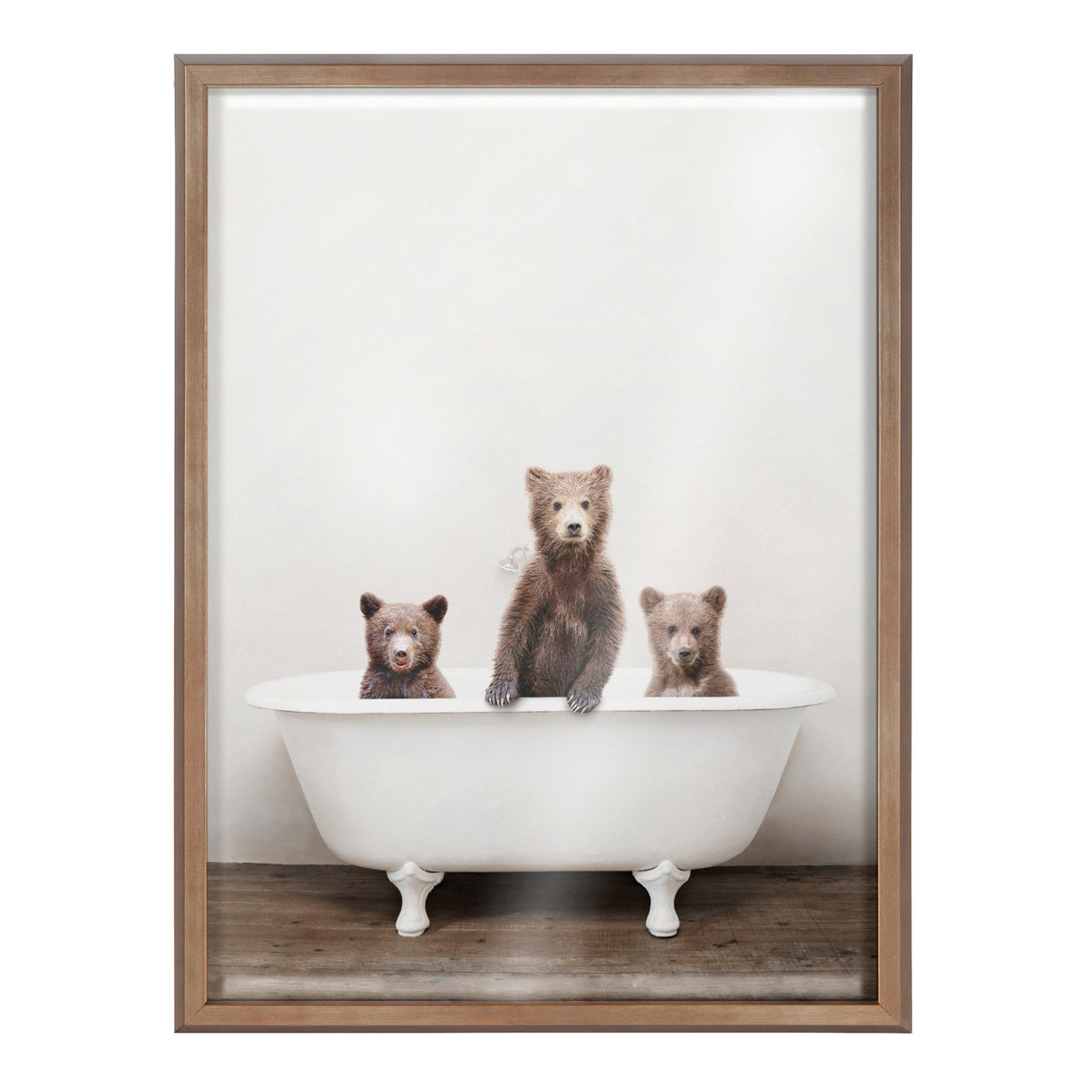 Three brown bear cubs sitting inside a white vintage clawfoot bathtub on a wooden floor, against a plain light background, with the center cub standing taller.