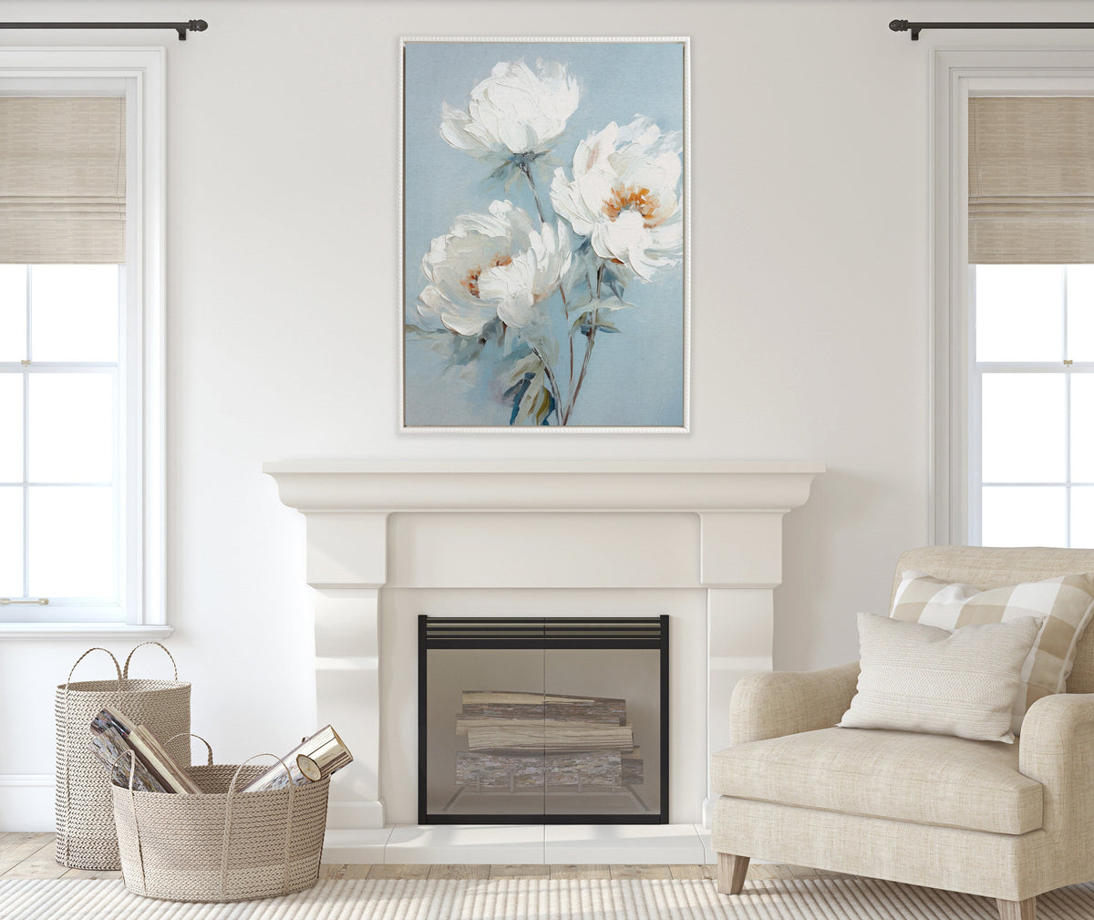 Framed canvas of white peonies with delicate brushstrokes on an ocean blue background hangs above a white fireplace between two windows in a neutral-toned living room.