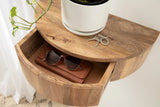 Half-round wooden side table with a smooth grain finish, featuring an open curved drawer holding sunglasses and a leather case, topped with a white potted plant and keys.