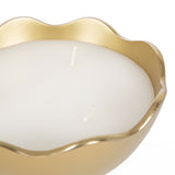 Close-up of a white double-wick candle inside a glossy gold metal bowl with a wavy rim detail on a white background.