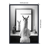 Black and white photo of a llama seen from behind looking at its reflection in a bathroom mirror, with potted plants on the sink counter and a white curtain in the background.