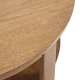 Close-up of a round wooden coffee table with a smooth surface and visible wood grain, showing part of the top and side with open shelf below.