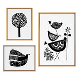 Set of three black-and-white linocut prints featuring a heart-shaped leaf tree, a pair of patterned birds stacked beside flowers, and a stylized bird with floral motifs on its wings.