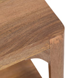 Close-up of a Dahl Rectangle Coffee Table corner showing smooth walnut wood grain and rounded edge with a joint connecting the tabletop to a tapered leg and support brace.