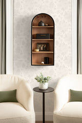 Tall, arched wood wall shelf with black frame, featuring four shelves holding a black vase, small box, photo frame, and decorative objects against light patterned wallpaper.