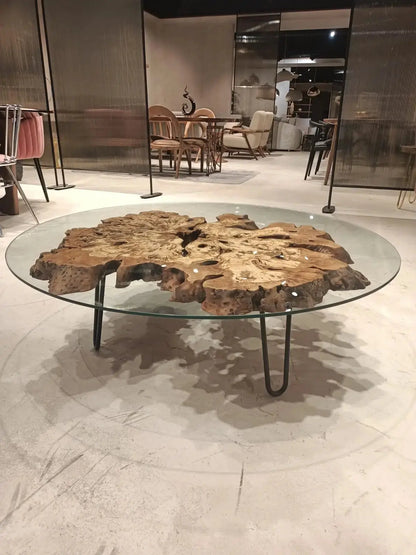 Olive wood rustic coffee table with clear glass top and stone-inspired wooden legs