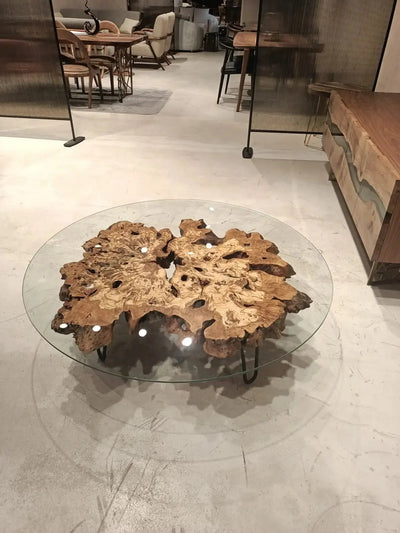 Olive wood rustic coffee table with clear glass top and stone-inspired wooden legs